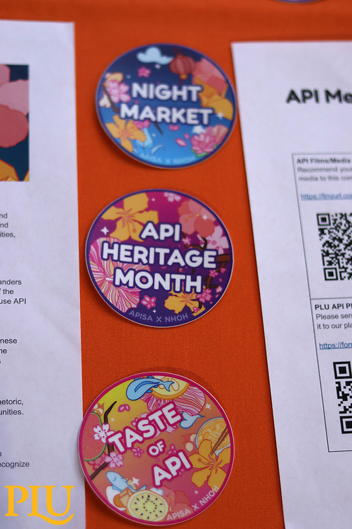 Night Market, API Heritage Month and Taste of API stickers on a table