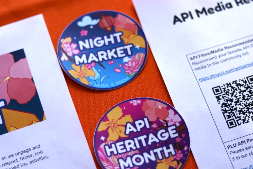 Night Market and API Heritage Month stickers on a table